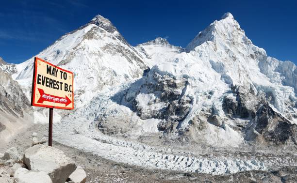 Everest, Lhotse and Nuptse, Nepal himalayas mountains signpost way to mount Everest b.c. and Mount Everest, Lhotse and Nuptse from Pumo Ri base camp - way to Mount Everest base camp, Nepal himalayas mountains base camp photos stock pictures, royalty-free photos & images