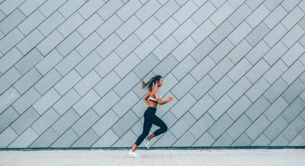 istock Woman jogging in the city 1125455452