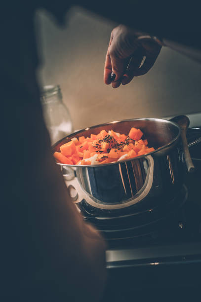 istock Close Up Woman Hands Cooking Pumpkin Soup 1125457793