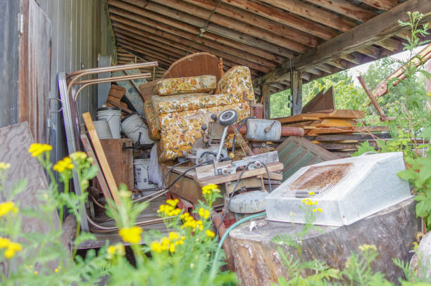 Trash area with vintage materials under old shed in rural Minnesota Trash area with old couch, chairs, motor, and other random antique household materials under old shed in rural Minnesota greed photos stock pictures, royalty-free photos & images