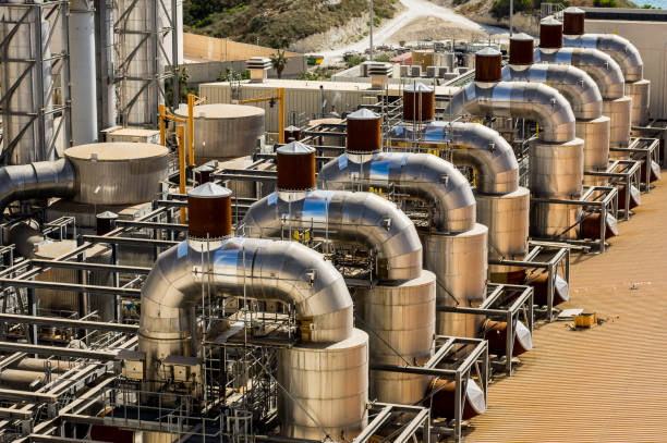istock Factory with many pipes around an industrial building 1125467514