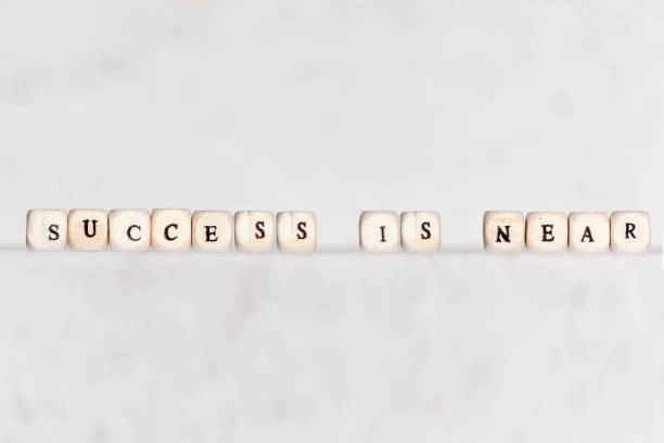 istock Cubes with the words SUCCESS IS NEAR on a gray concrete background. Selective focus. 1125468885