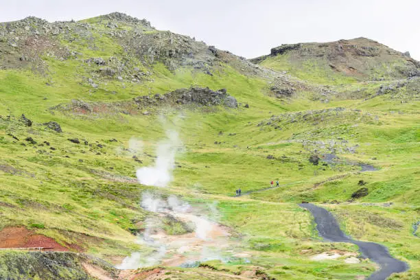 Reykjadalur, Iceland Hveragerdi Hot Springs road path with steam during autumn summer landscape morning day in golden circle with people on hiking trail