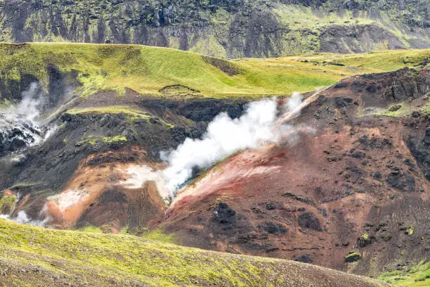 Reykjadalur, Iceland Hveragerdi Hot Springs steam fumarole vent during day in golden circle landscape with nobody and colorful rock