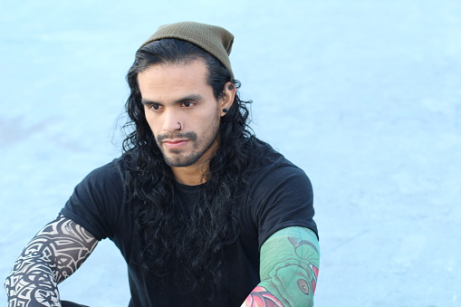 Tough Looking Hispanic Man With Long Hair And Tattoos Stock Photo -  Download Image Now - iStock