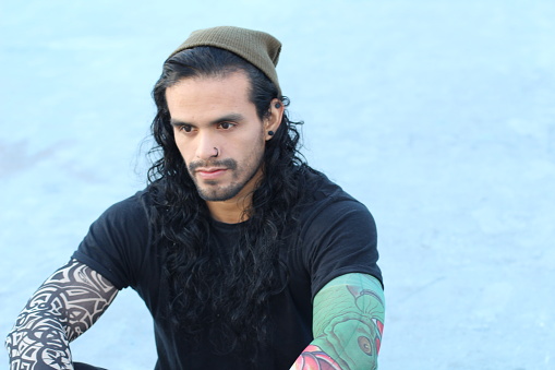 Tough Looking Hispanic Man With Long Hair And Tattoos Stock Photo - Download Image Now - iStock Tough Looking Hispanic Man With Long Hair And Tattoos Stock Photo - Download Image Now - iStock
