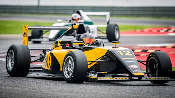 istock Black and yellow formula race car on the track 1125471595
