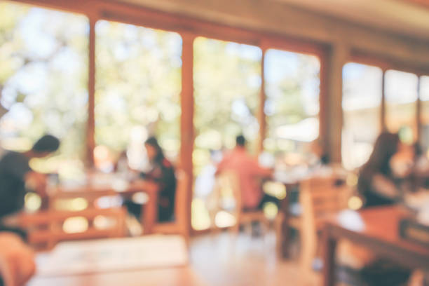 istock Restaurant cafe or coffee shop interior with customer blur abstract vintage style bokeh light for montage product display background 1125482902