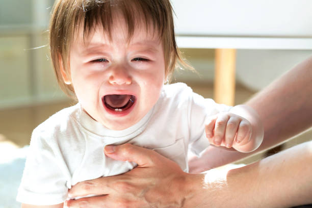 istock Upset toddler boy crying in his house 1125484441