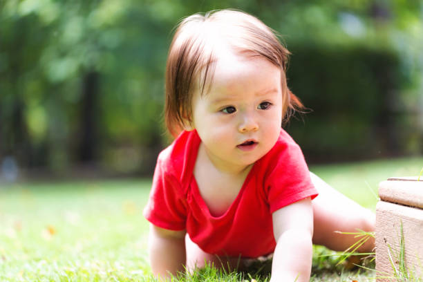istock Happy baby boy playing outside 1125484510