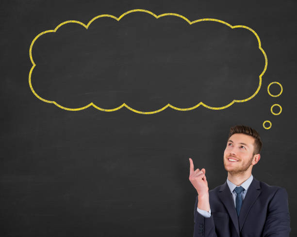 istock Business man standing next to thought bubble drawn on chalkboard 1125484609