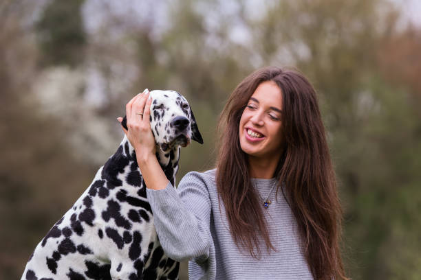 istock young woman with Dalmatian dog 1125486555