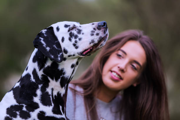 istock young woman with Dalmatian dog 1125486589