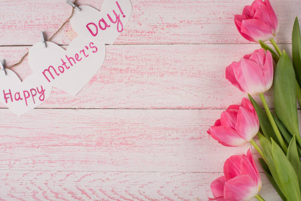 istock tulips and gifts on a paper texture 1125490020