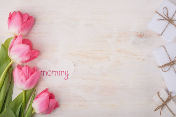 istock tulips and gifts on a paper texture 1125491858