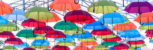 Ho Chi Minh City, Vietnam - December 22nd, 2018: Colorful umbrellas hung in the sunny sky. Street decoration in tourist areas to attract visitors in Ho Chi Minh City, Vietnam