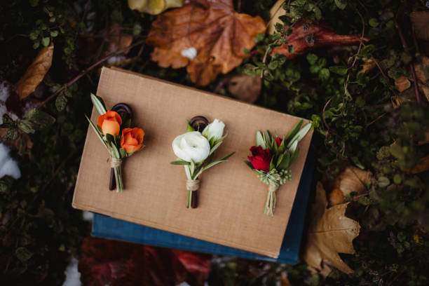 Wedding boutonniere Three wedding boutonnieres on old books buttonhole flower stock pictures, royalty-free photos & images