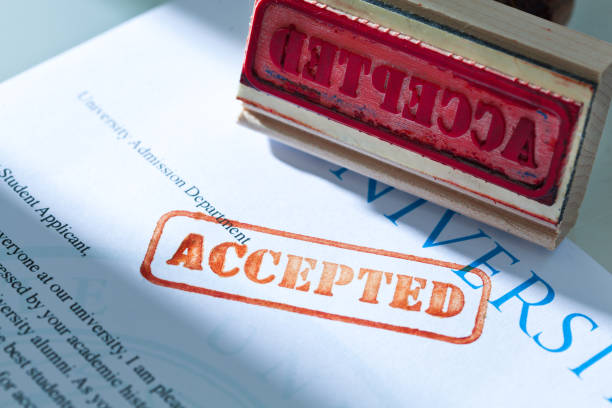istock University Application Acceptance Letter Still Life with Rubber Stamp of ACCEPTED 1125504672