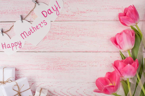 istock tulips and gifts on a paper texture 1125506948
