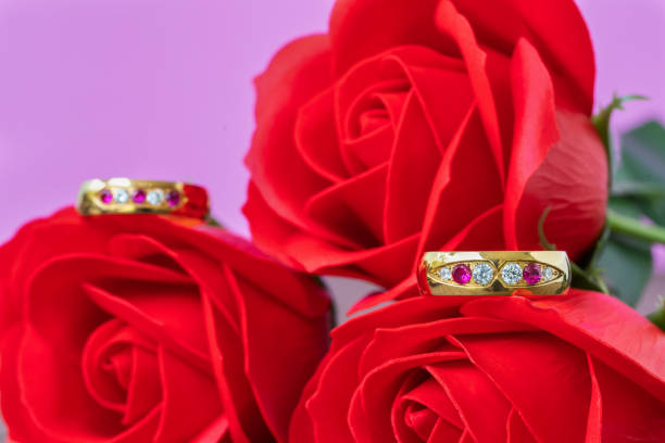 istock Close up wedding ring and red rose 1125519846