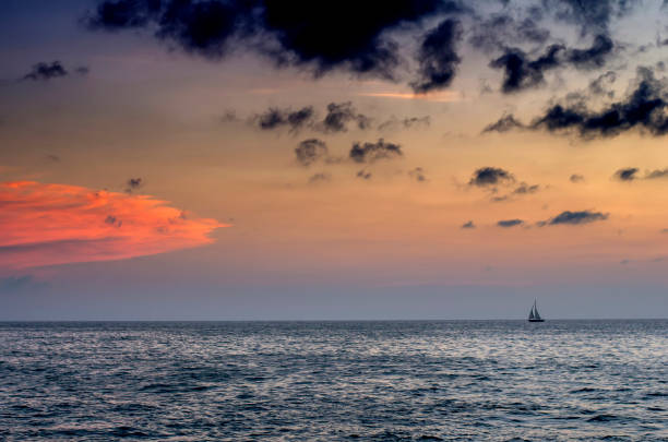 istock sailing boat on horizon at sunset 1125520664