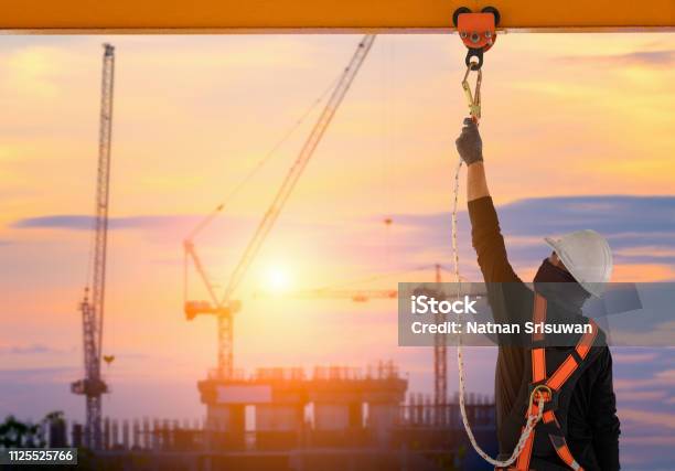 Construction Worker Wearing Safety Harness Stock Photo - Download Image Now - Falling, Construction Site, Construction Industry