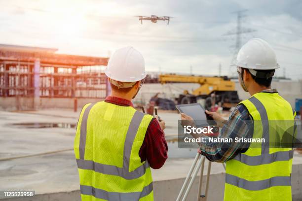 Drone Operated By Construction Worker Stock Photo - Download Image Now - Drone, Construction Industry, Construction Site