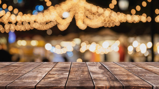 istock Empty wood table top on abstract blurred restaurant and nightclub party lights background - can be used for display or montage your products 1125527841