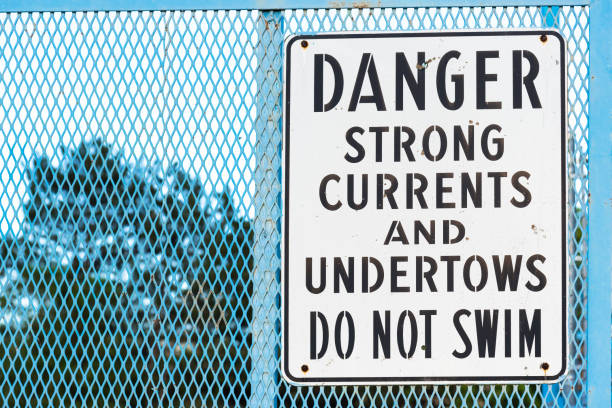 istock Sign by river warning of strong currents and undertows no swimming 1125529954