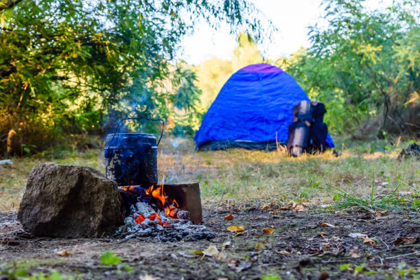 istock Cooking food in a kettle on bonfire. Tent on background 1125535669
