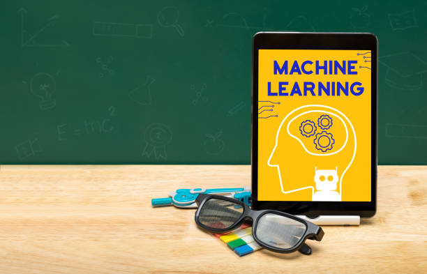 istock Machine learning bot on tablet with glasses on wood table and green blackboard with copy space for adding text.Artificial intelligence learning concept. 1125544120