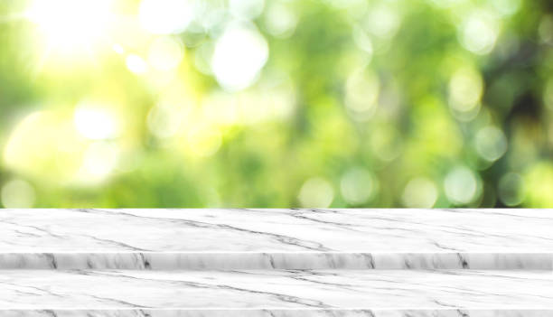 istock Empty white marble table top with blur tree in park with bokeh light at background,Mock up template for display of your design,Banner for advertise of product,panorama view 1125544138