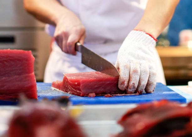 istock Chef cutting fresh tuna fish in the kitchen 1125547770