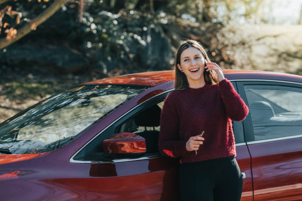 istock Young woman outside the car using smartphone 1125548387