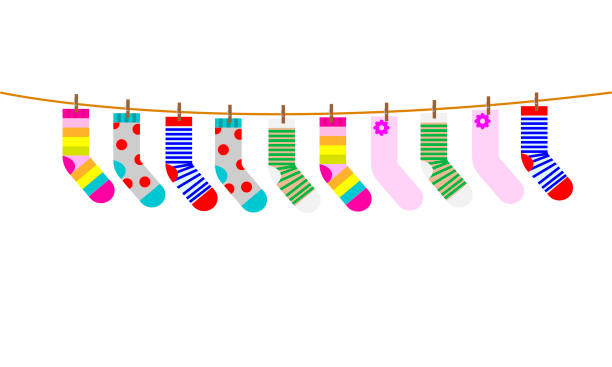 illustrazioni stock, clip art, cartoni animati e icone di tendenza di una serie di calzini per bambini vengono asciugati su una corda. illustrazione vettoriale. - sock wool multi colored isolated