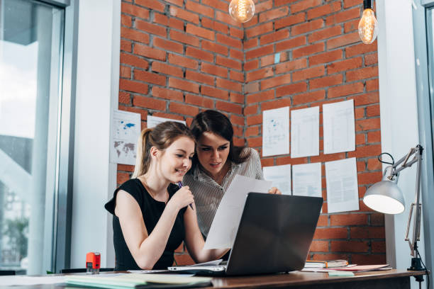 istock Two female colleagues in office working together. 1125551697