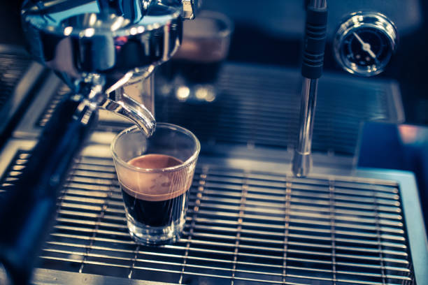 istock Close up of espresso pouring from coffee machine. 1125554381