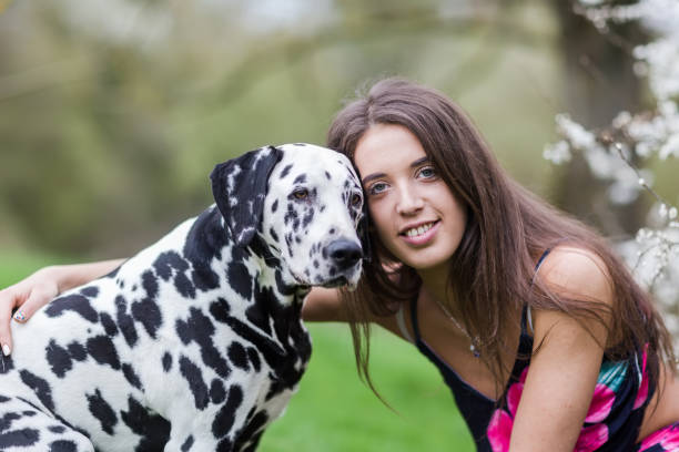 istock young woman hugs a Dalmatian dog 1125557149