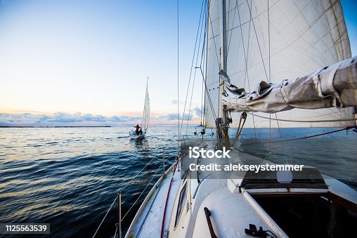 istock Clear evening sky at sunset. Two yachts sailing. A view from the deck to the bow and sails, close-up. Baltic sea, Latvia 1125563539
