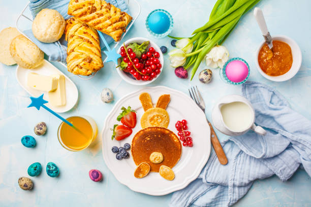 istock Easter bunny of pancakes with berries. Easter Breakfast table. Blue background, top view. 1125564709