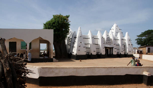 The great Mosque at Djenne in Mali - constructed from the mud of the Niger River and here illuminated in the rose glow of dawn