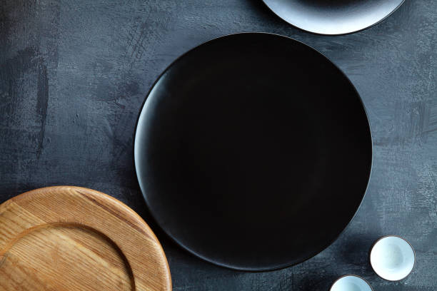 istock Empty food tableware wooden cutting board utensils and black plate on dark background. Restaurant, food menu, cafe concept. 1125568711