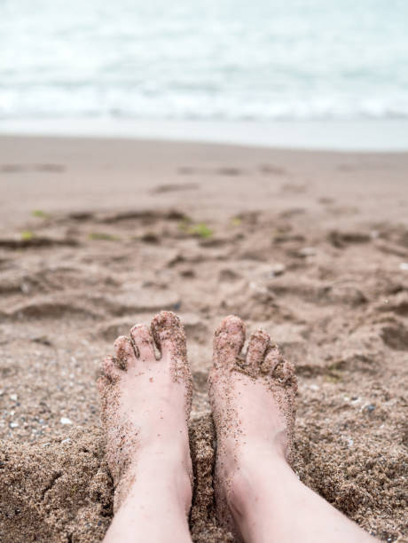 istock Feet on sand near the sea 1125568996