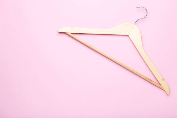 istock Wooden hanger on pink background 1125570713