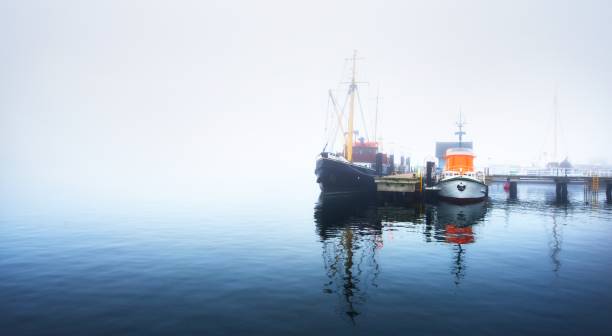 istock A pier with small boats under fog 1125571012