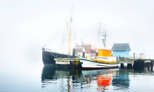 istock A pier with small boats under fog 1125571013