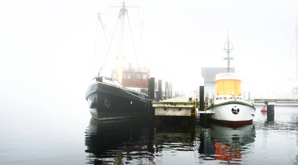 istock A pier with small boats under fog 1125571018