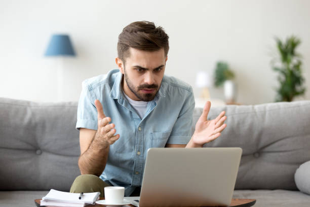 istock Mad stressed young man angry about stuck laptop data loss 1125572480