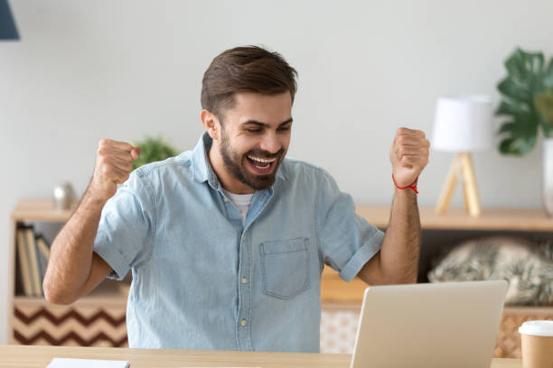 istock Euphoric young man celebrating success excited by online bet win 1125572502