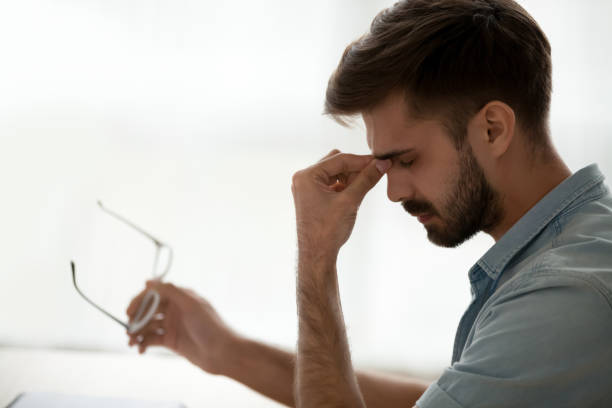 istock Tired stressed guy taking off glasses feeling eyestrain or headache 1125572513